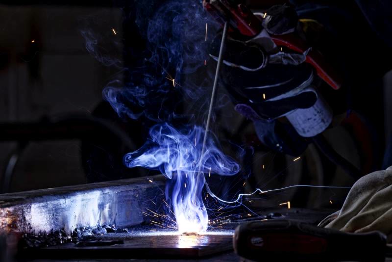 Close-up of a tradesperson welding on site